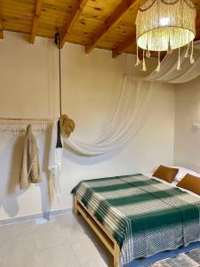 a bedroom with a bed and a chandelier at Timber House Dahab in Dahab +8 photos