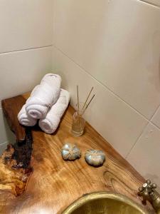 a bathroom with a sink and towels on a wooden counter at Timber House Dahab in Dahab