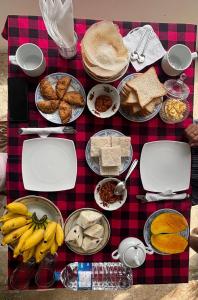 a table topped with lots of different types of food at My Guest Mirissa in Mirissa