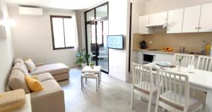 a living room and kitchen with a couch and a table at Casa Nature in Playa de Santiago