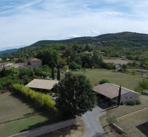 an aerial view of a house with mountains in the background at Mirabel #2, Maisonette, terrace and pool access in Grospierres