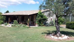 a small house with a tree in front of it at Mirabel #2, Maisonette, terrace and pool access in Grospierres