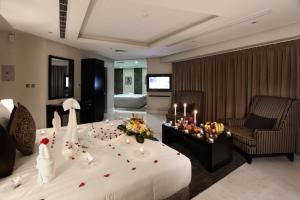 a hotel room with a large bed with flowers on it at سدو بوتيك الخبر in Al Khobar +20 photos