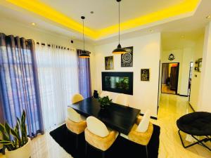 a living room with a black table and chairs at Gimhani Villa Hiriketiya in Dickwella