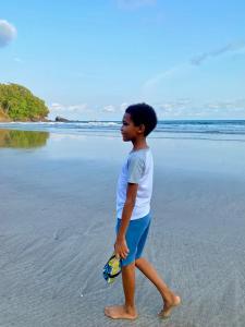 a young man walking on the beach at 7 Ventos in Alto Douro