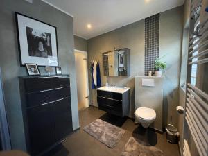 a bathroom with a sink and a toilet at Close to Goettingen - unweit von Göttingen in Nörten-Hardenberg +31 photos