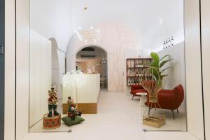 a store with red chairs and a table in a room at Dama Bianca Boutique Hotel Ostuni in Ostuni