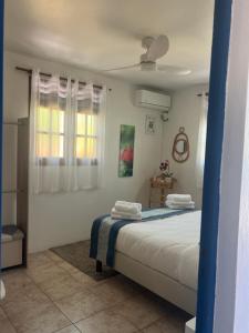 a bedroom with a bed with two towels on it at Vi la dous Kreyol in Sainte-Rose
