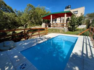 a swimming pool in front of a house at Mafalda in Tanti