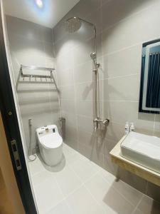 a bathroom with a toilet and a sink at Minimalhaven Stay in Vung Tau +53 photos