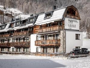 a large building in the snow in front of the lodge at The Lodge by Regina in Sölden