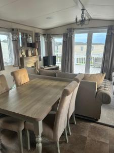 a dining table and chairs in a living room at Bude 20 in Newquay