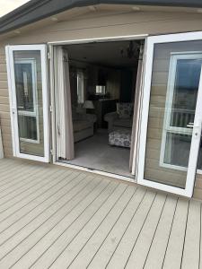 a sliding glass door on a porch of a house at Bude 20 in Newquay