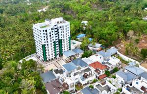 an aerial view of a large white building at Zenith apartement in Trivandrum