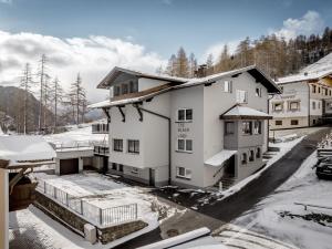 an apartment building with snow on the ground at The Black by Regina in Sölden