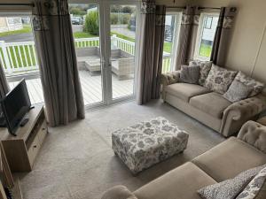 a living room with a couch and a tv at Bude 20 in Newquay