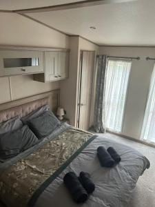 a bedroom with a bed with two pillows on it at Bude 20 in Newquay
