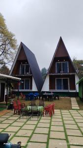 a large building with tables and chairs in front of it at Bethel Cottage in Kanthalloor