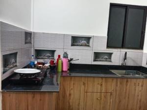 a kitchen with a sink and a counter top at Bethel Cottage in Kanthalloor