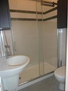 a bathroom with a sink and a shower and a toilet at Casa do Beco in Lisbon +15 photos