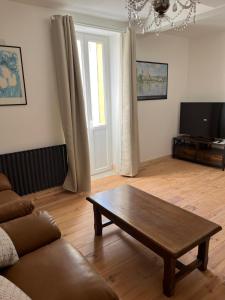 a living room with a couch and a coffee table at Gite St Vincent in Foix