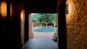an open door to a yard with a swimming pool at Bản Nhỏ - Little Village in Cao Bằng