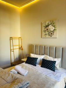 a bedroom with two beds with pillows on it at Μateo suite in Levádeia