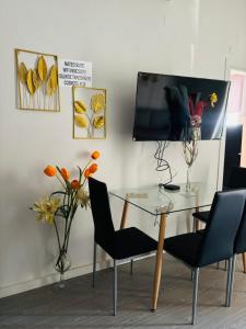 a dining room with a glass table and chairs at Μateo suite in Levádeia