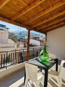 a glass vase sitting on a table on a balcony at Μateo suite in Levádeia