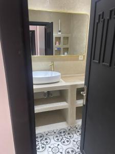 a bathroom with a sink and a large mirror at Chez balqis atlas golf in Marrakesh +7 photos