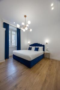 a bedroom with a large bed and blue curtains at SM Vatican Relais B&B in Rome