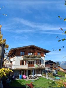 a large house with a balcony on top of it at chalet Mont-Blanc in Combloux