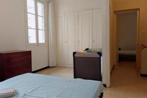 a room with a bed and a dresser and a window at Spacious house in Perpignan quiet and friendly in Perpignan