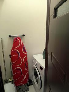 a bathroom with a surfboard on the wall next to a toilet at Studio Kath&Darc in Ruse