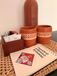 a table with some pots and a sign on it at Red Heritage Hiriketiya in Dickwella +31 photos