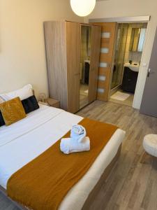 a bedroom with a bed with a towel on it at Le Cocon Bright Large TV Free parking in Fleury-les-Aubrais +10 photos