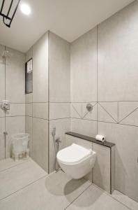 a bathroom with a toilet and a shower at The Grand Platinum Hotel in Ahmedabad