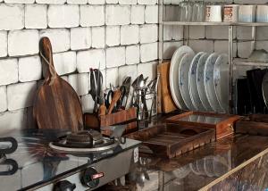 a kitchen counter with a bunch of plates and utensils at Private Farm Villa With Plunge Pool, Bir Billing - Rishi Casa Blu in Bīr