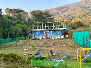 a house on top of a hill with a playground at Private Farm Villa With Plunge Pool, Bir Billing - Rishi Casa Blu in Bīr