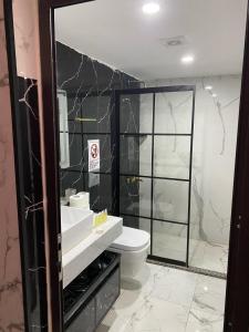 a bathroom with a toilet and a sink and a mirror at RUM NADINE LUXURY CAMP & Bubbles Hotel in Wadi Rum