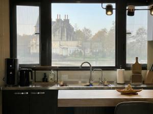 a kitchen with a sink and a large window at Forgotten Boundless Offland in Wujie +13 photos