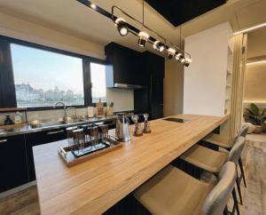 a kitchen with a large wooden table and chairs at Forgotten Boundless Offland in Wujie