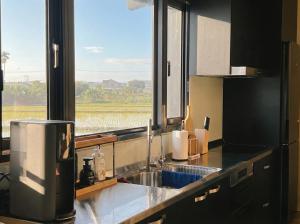a kitchen with a sink and a large window at Forgotten Boundless Offland in Wujie