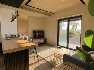 a living room with a tv and a dining room at Forgotten Boundless Offland in Wujie