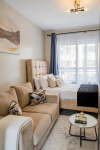 a living room with a couch and a bed at Navira Studio with Pool in Nairobi