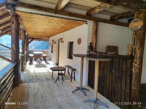 a room with a table and chairs in a building at River Haus in Călineşti