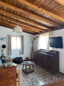 a living room with a flat screen tv and a table at Evergreen in Mar del Plata