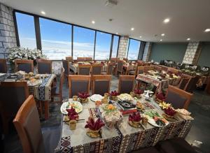a dining room with tables and chairs with flowers on them at Beautiful Sapa Hotel in Sa Pa +38 photos
