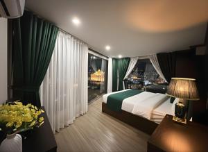 a hotel room with a bed and a large window at Beautiful Sapa Hotel in Sa Pa
