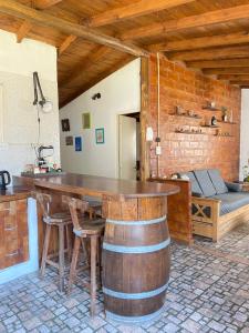 a room with a large wooden table and a bed at Evergreen in Mar del Plata